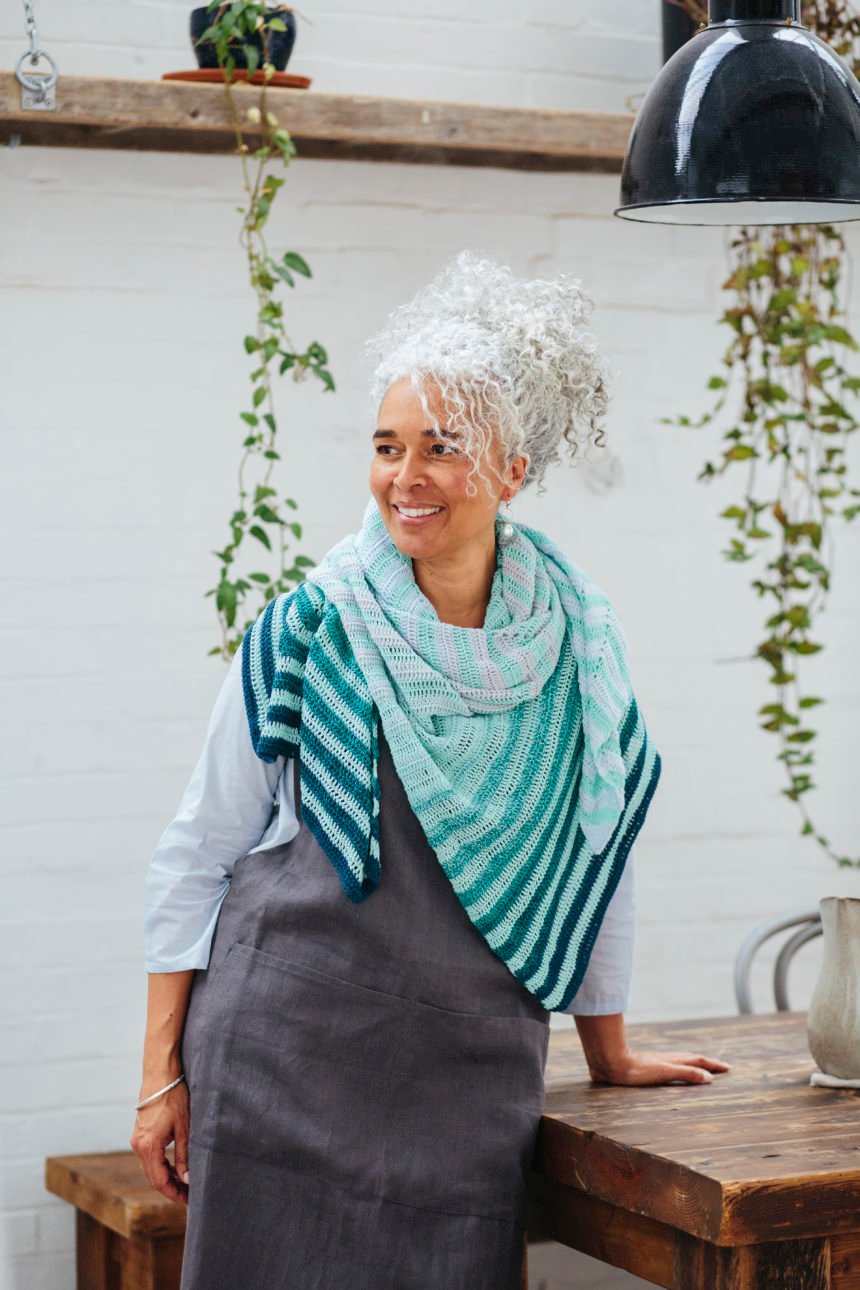 model wearing crochet shawl wrapped around neck