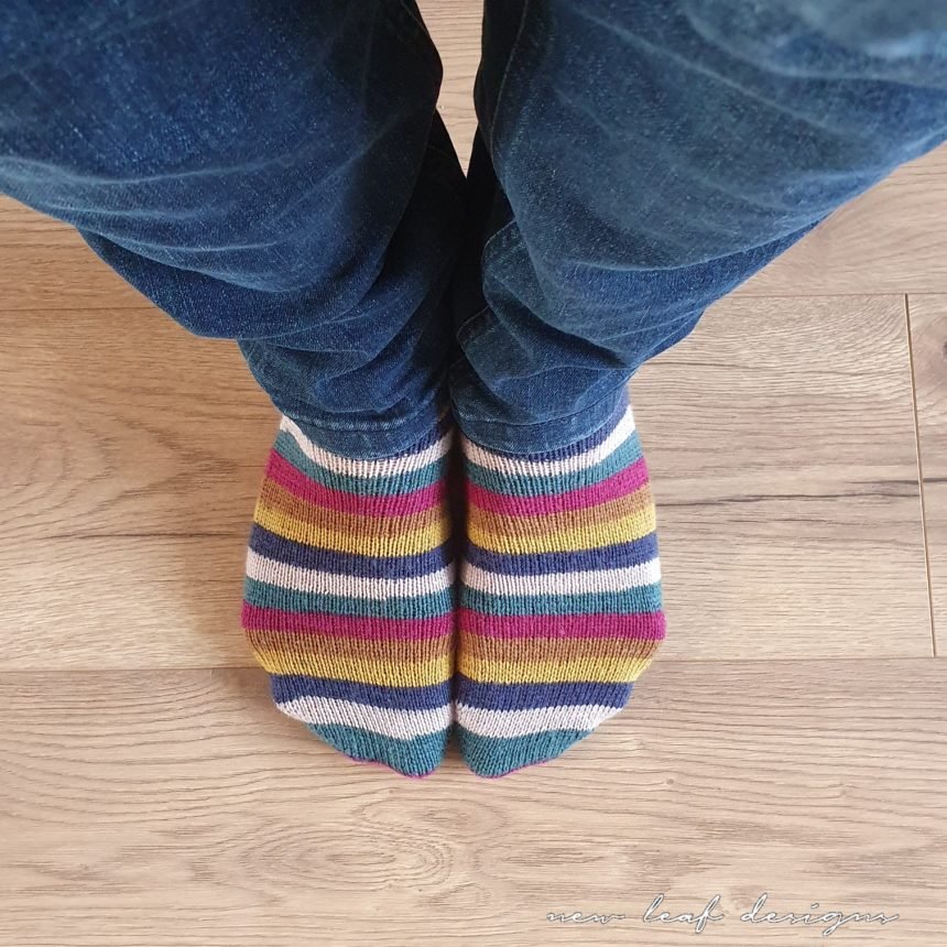 close up of two feet wearing socks, the image is taken while standing and looking down at feet